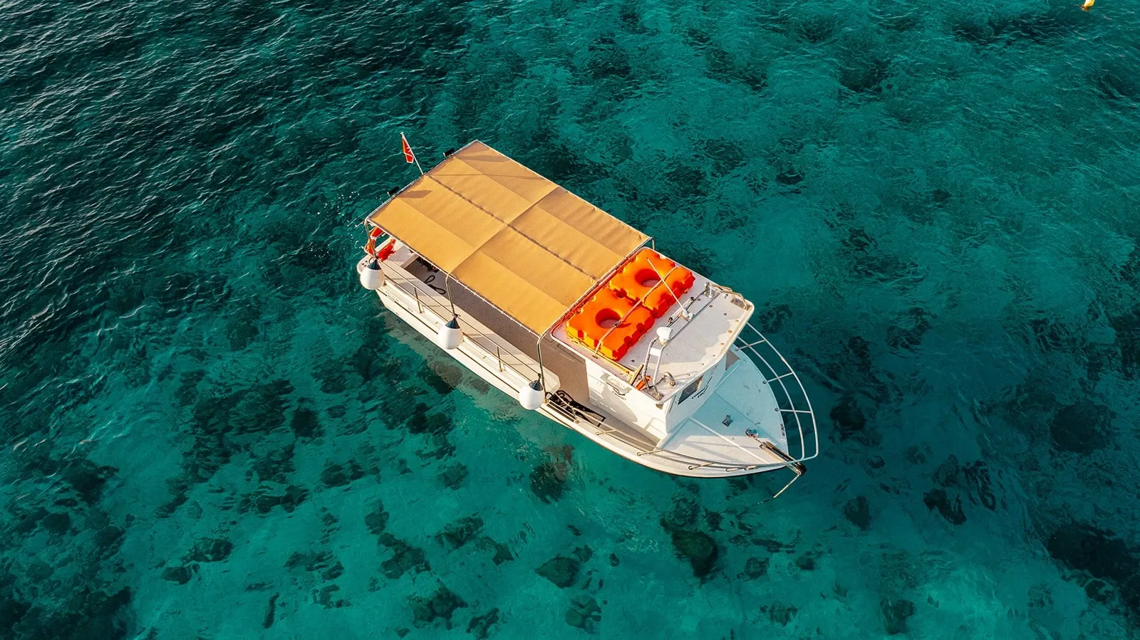 Aerial view of the Comino Land boat and shaded deck